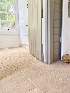 a dog laying on the floor next to a door