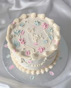 a white cake with pink and blue frosting