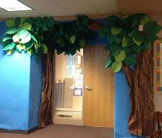 an office decorated with paper trees and blue walls