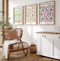 a room with three flower market posters on the wall