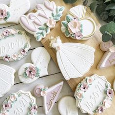 decorated cookies are arranged on a wooden table