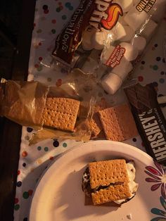 a plate topped with two pieces of cake next to a bag of marshmallows