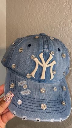 Adjustable NY Custom Bedazzled Hat customed by ShanayCosmetics Comes in 2 colors: Black or Green New Restock Coming Soon with colors Pink & Denim. Green and Black will be returning as well. PLEASE KEEP IN MIND THAT I AM NOT RESPONSIBLE FOR ANY DELAYS WITH SHIPPING ONCE I HAVE DROPPED YOUR PACKAGE OFF AT THE POST OFFICE! THAT IS OUT OF MY CONTROL. PLEASE BE AWARE I AM NOT RESPONSIBLE FOR ANY LOST, DAMAGED OR STOLEN PACKAGES!! Cricut Hat Ideas, Trendy Snapback Baseball Cap With Rhinestones, Trendy Rhinestone Baseball Cap, Bedazzled Hats Baseball Caps, Trendy Rhinestone-embellished Hats, Rhinestone Baseball Cap One Size, Jean Rose, Trucker Hat Fashion, Swag Hats