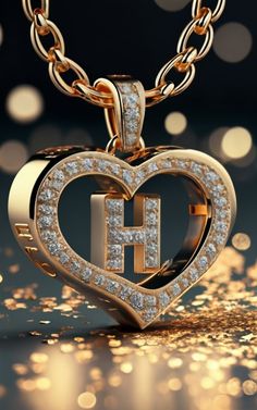 a heart shaped pendant with the letter h in it's center surrounded by sparkling lights