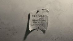 a piece of paper taped to the side of a wall with writing on it that says life goals