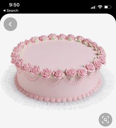 a pink cake decorated with roses on a white plate