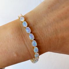 -18kt gold vermeil (sterling silver base) -lab created blue opals -6. 5'' length   Mesmerizing and unique blue opal tennis bracelet made up 18kt gold vermeil (sterling silver base) and beautiful blue opal stones. The bracelet measures 6. 5'' in length. To extend the life of your gold plated and vermeil jewelry, avoid wearing when washing hands, showering, applying lotion, using harsh cleaning supplies or working out. To clean, buff gently with a soft and dry 100% cotton cloth or a microfiber cloth. Do not use jewelry cleaner on gold plated jewelry. Opal Tennis Bracelet, Jewel Design, September Birthstone Jewelry, Jewelry Lookbook, Vermeil Jewelry, Jewelry Ring Box, Pearl Jewellery Earrings, Men's Jewelry Rings, I Love Jewelry