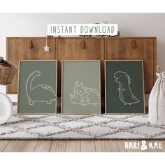 three framed dinosaurs are on the floor in front of a dresser and wall hangings