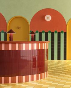 the interior of a brightly colored building with tiled flooring and walls painted in different colors