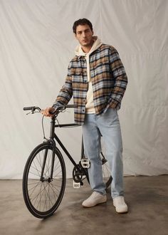 Stay effortlessly cool this fall with a layered plaid shirt over a cozy hoodie, paired with light-washed jeans for a laid-back yet stylish look. Perfect for biking through the city or a casual day out, this outfit blends comfort and style seamlessly. Complete the ensemble with classic white sneakers for that clean, fresh touch. Ideal for urban explorers who love keeping it relaxed yet fashionable. # Mens Fall Outfits, Plaid Shirt Outfits, Hoodie Outfit Men, Jeans Outfit Men, Boyfriend Outfit, Flannel Outfits, Outfits Hombre, Fall Outfits Men, Winter Outfits Men