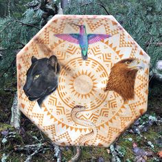 an umbrella with animals on it in the woods