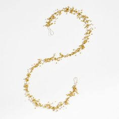 a gold and white beaded necklace on a white background