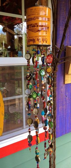 a wind chime hanging from the side of a building with lots of beads on it