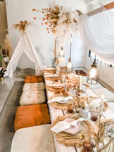 a long table is set with place settings for dinner guests to sit down and eat