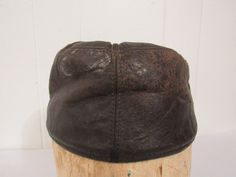 "Vintage 1950s hat. Made of brown leather. Has a corduroy flip down ear cover and quilted lining. Made by the denim jeans company LEE. Label reads: LEE GENUINE LEATHER. Hat is about a size medium(7) with the ear flap down and is a size small(6 7/8) with the flap up inside. Hat is in good condition. Has some leather surface breaks and some paint. Inside 5\" of lining at front sweatband is deteriorated." Vintage Leather Hats For Winter, Vintage Leather Hats For Outdoors, Vintage Brown Hats For Outdoor, Vintage Fitted Hats For Outdoor, Vintage Hat With Leather Sweatband And Short Brim, Vintage Brown Hat With Flat Brim, Vintage Leather Hat With Short Brim, Vintage Leather Hat With Leather Sweatband, Vintage Fitted Outdoor Hat