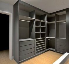 an empty walk in closet with lots of drawers and shelving unit doors open on the wall