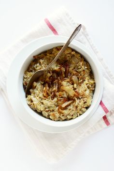 a white bowl filled with oatmeal on top of a red and white towel