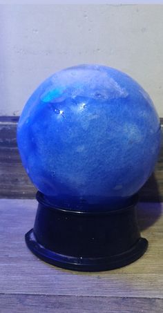 a blue ball sitting on top of a wooden table