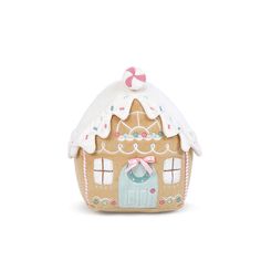 a small gingerbread house with a pink bow