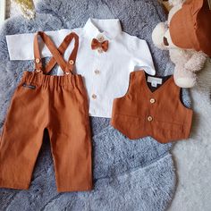 Different color high quality pure linen baby boy suit. 🌿This offer consists of a : linen white shirt sleeve shirt, Linen vest, linen pants and linen hat. 🌿Linen vest has cotton lining and is decorated with wooden buttons. 🌿Linen shirt has long/short sleeve and wooden buttons. You can choose this shirt with a short sleeve too. 🌿Linen pants has suspenders with regulations on it. 🌿Linen hat is without lining, it is breathable and fitted. All set is made with Oeko-Tex Standard sertyficat fabric, is antiallergenic, eco-friendly and natural product. This suit is perfect for different occasions: wedding day, birthday, christening and other. 🌿Color you can choose. Product care: Wash into 30-40 degrees water and rinse carefully End Of Summer Wedding Ideas, Terracotta Country Wedding, Ring Bearer Fall Wedding, Groom Suit Fall Wedding, Ring Bearer Outfit Fall, Boho Ring Bearer Outfit, Terracotta Ring Bearer Outfit, Terracotta Fall Wedding, Burnt Orange Vest Wedding