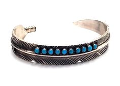 ** RUSH SHIPPING IS AVAILABLE! GET YOUR ITEMS IN TIME FOR CHRISTMAS! ** Turquoise feather cuff bracelet in sterling silver.  This adjustable turquoise bracelet is perfect for both men and women. This type of small stone work is called snake eye and the lovely feather design of this piece makes this piece of Navajo jewelry very special.  The diameter of this cuff is 5.5" with a 1" gap and is .25" wide at the widest point.  It is crafted of heavy gauge silver so there's not alot of ability to adju Christmas Turquoise, Feather Cuff Bracelet, Feather Cuff, Feather Bracelet, Feather Ring, Navajo Jewelry, Turquoise Bracelet Cuff, Silver Feather, Turquoise Cuff