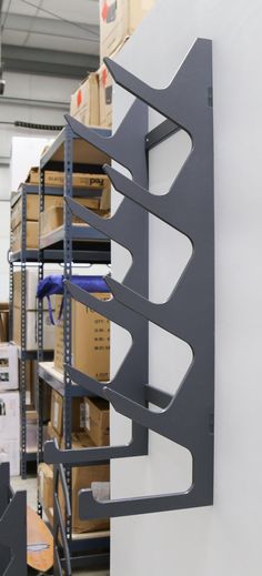 a metal shelf with several shelves in the background