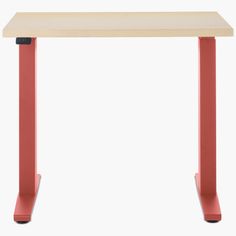 a wooden table with red legs and a white top on an orange stand up desk