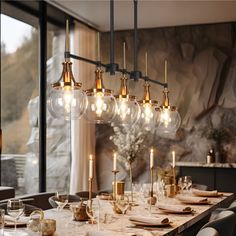 a dining room table is set with candles and place settings