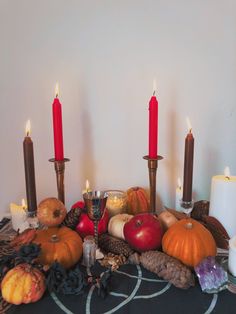 a table topped with candles and pumpkins