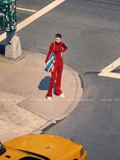 a man in red is standing on the street