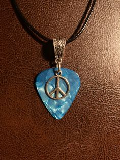 One of a kind blue guitar pick charm necklace with peace sign. Peace Sign Jewelry, Peace Jewelry, Blue Guitar, Peace Necklace, Peace Sign Necklace, Stone Ornaments, Hippie Necklace, Hippie Jewelry, Butterfly Charm