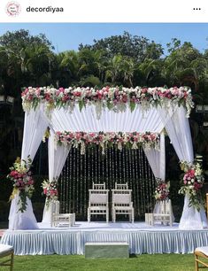 an outdoor wedding setup with white and pink flowers