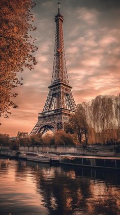 the eiffel tower in paris, france is reflected in the water at sunset