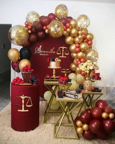 a table topped with cakes and balloons