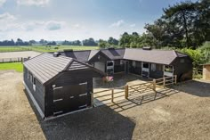 an aerial view of a horse barn in the country