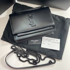 Sunset Chain Wallet In Smooth Leather Saint Laurent Monogram Chain Wallet With Leather Top Handle, Decorated With Metal Ysl Initials, Featuring A Flap With Magnetic Fastening And A Detachable Leather And Chain Strap. 100% Calfskin Leather Dimensions: 19 X 14 X 5,5 Cm / 7.4 X 5.5 X 2.1 Inches Handle Drop: 4 Cm / 1.5 Inches Shoulder Strap Drop: 53 Cm / 20.8 Inches Black Metal Hardware Magnetic Snap Closure Exterior: One Flat Pocket At The Back Interior: One Main Compartment, One Bill Compartment, Ysl Sunset Chain Wallet, Ysl Card Holder, Ysl Wallet, Envelope Wallet, Saint Laurent Wallet, Yves Saint Laurent Bags, Wallet On Chain, Chain Wallet, Black Wallet