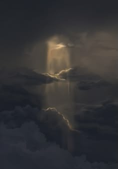 the light shines through the dark clouds