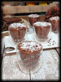 three glasses filled with chocolate desserts sitting on top of a table