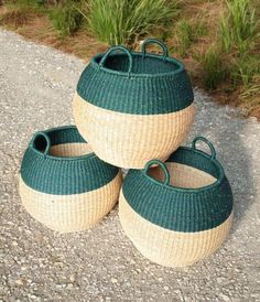 three green and white baskets sitting on the ground