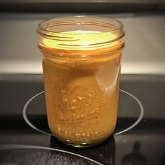 a glass jar filled with liquid sitting on top of a stove