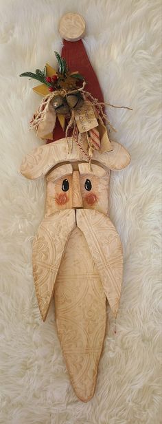 a wooden santa claus mask on a white rug