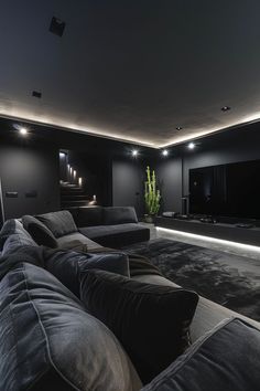 a living room filled with furniture and a large flat screen tv mounted to the wall