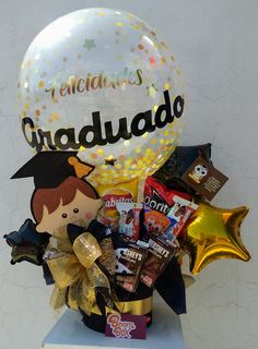 a graduation gift basket with balloons, chocolates and confetti for someone special