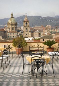 tables and chairs on the roof of a building