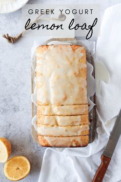 a loaf of lemon bread sitting on top of a counter next to sliced oranges