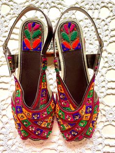 Hand crafted & hand embroidered leather Peshawari Chappal - in 100% leather embellished with Multi Color thread Work & Sequence  Available in UK Size 4, 5 ,  Each item is individually crafted by a unique artisan and reflects his creativity and expression ! A Peshawari Chappal is a Traditional footwear design of Pakistan & takes its name from the city of Peshawar  It is a semi closed footwear consisting of two wide strips which cross over each other to join the sole of the sandal  The Peshawari Chappal has become increasingly popular in the fashion space of Pakistan . The urban youth wear this very often with jeans and Western clothes The Classic style of this shoe make it a perfect accessory for Weddings , Parties and Christmas events. Ideal for  casual and formal wear with both Eastern as Bohemian Multicolor Embroidered Sandals, Embroidered Multicolor Open Toe Sandals, Multicolor Embroidered Open Toe Sandals, Traditional Embroidered Sandals For Summer, Traditional Sandals For Festivals And Parties, Traditional Festive Sandals For Party, Festive Multicolor Flat Sandals, Embroidered Closed Toe Sandals For Festival, Traditional Festive Party Sandals