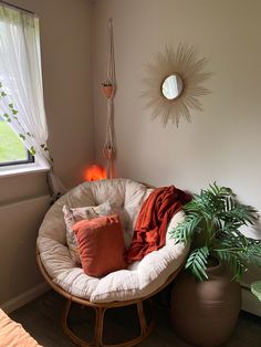 a room with a chair, potted plant and mirror