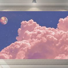 there is a pink cloud in the sky with a full moon behind it and a brick wall