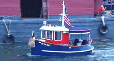 a red, white and blue boat with an american flag on it