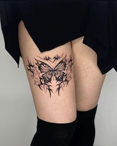 a woman's thigh with a butterfly tattoo on it